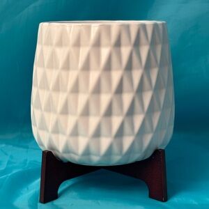 White vase with wooden stand